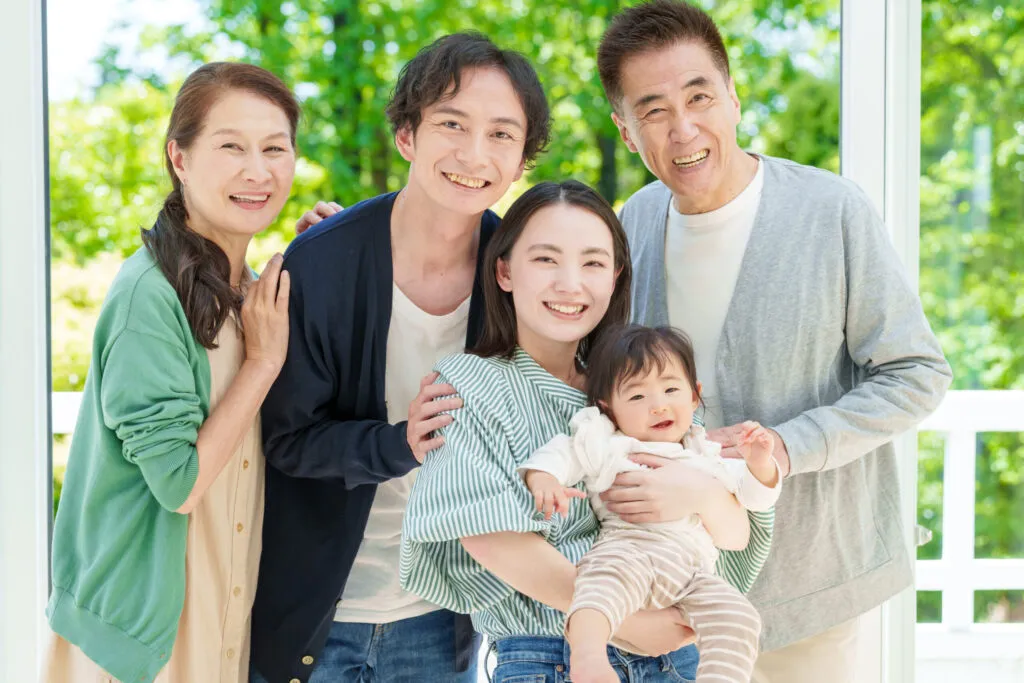 玄関先で寄り添う三世代家族